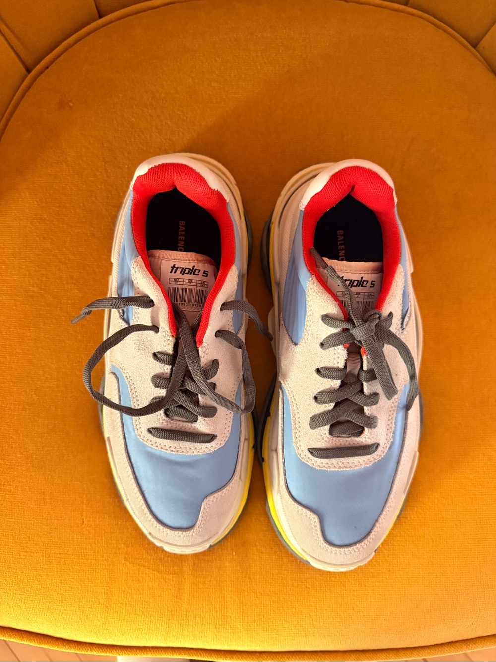 Balenciaga Triple S sneakers featuring a blue, white, and neon yellow colorway.